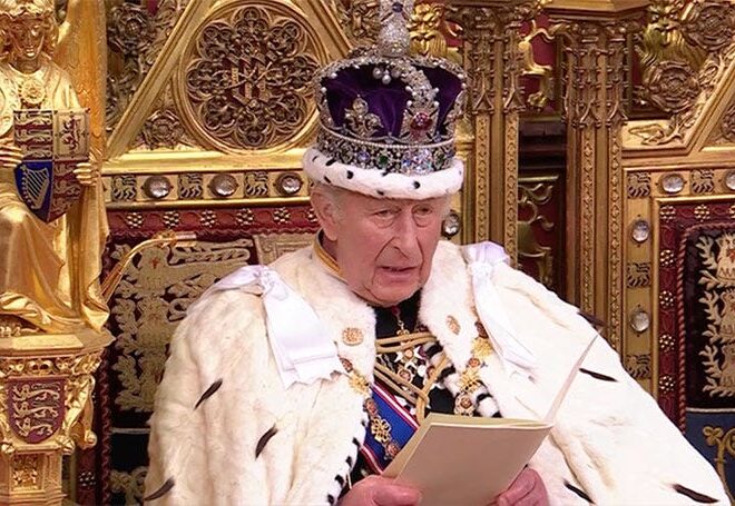Man in silly outfit cheerfully announces new age of authoritarianism on behalf of prime minister everyone hates